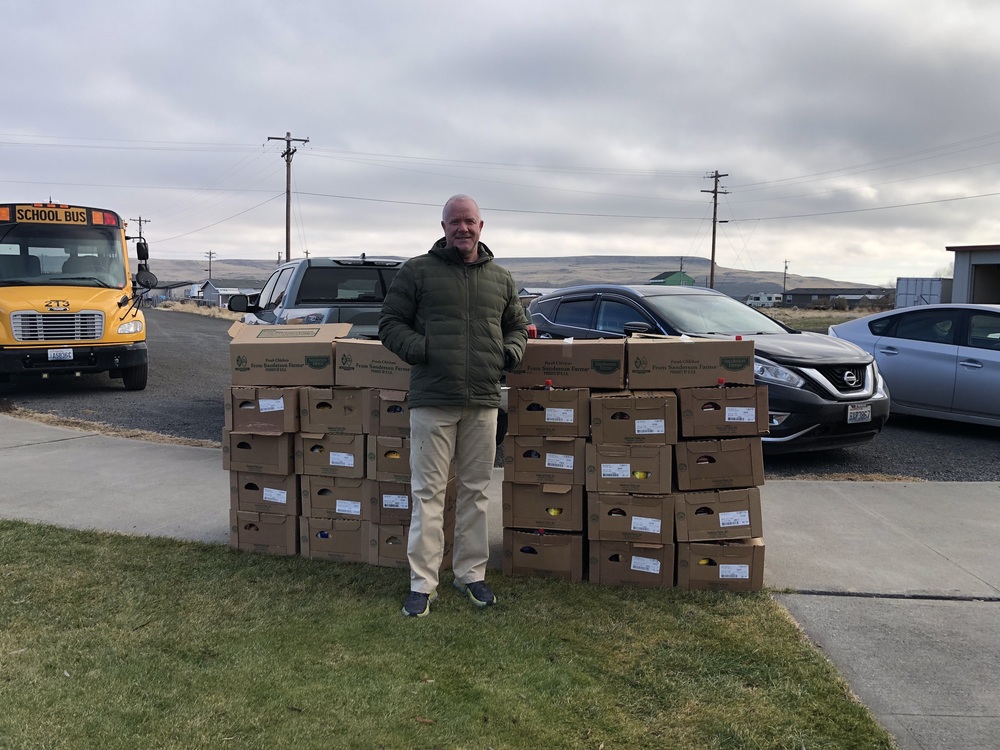 man standing in front of food boxes 